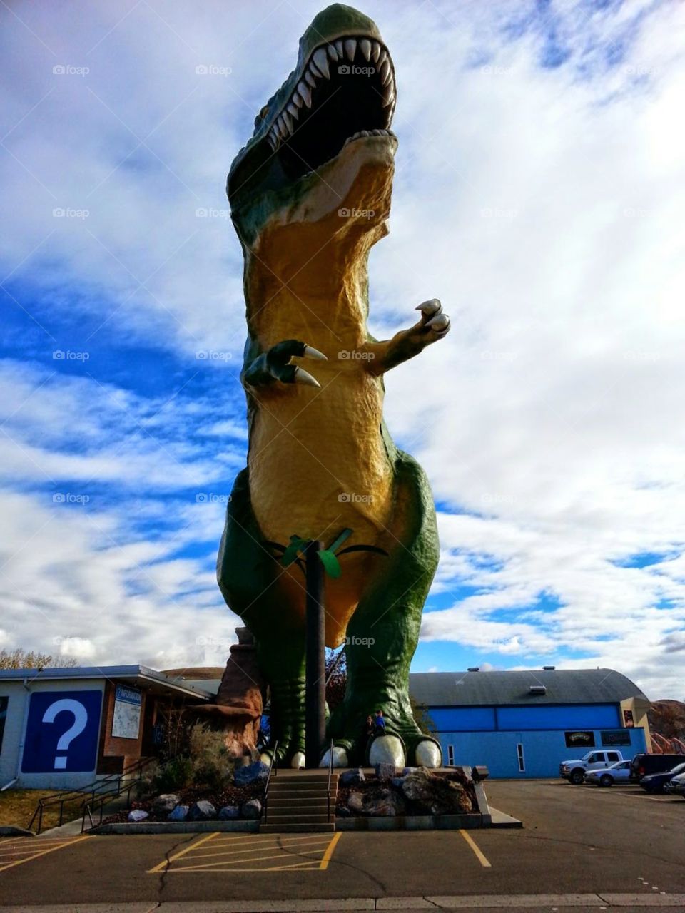 dinosaur statue outside cloudy day
