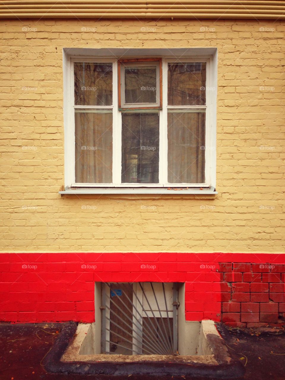 White window on yellow wall in Moscow