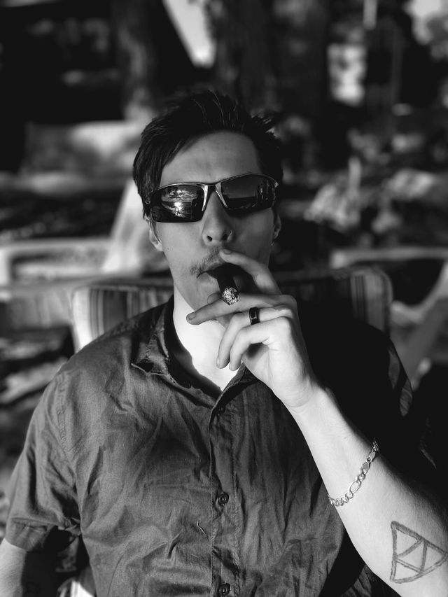 Man in sunglasses smoking cigar black and white portrait 