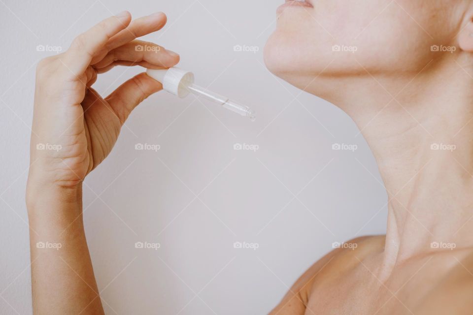 Woman using beauty serum