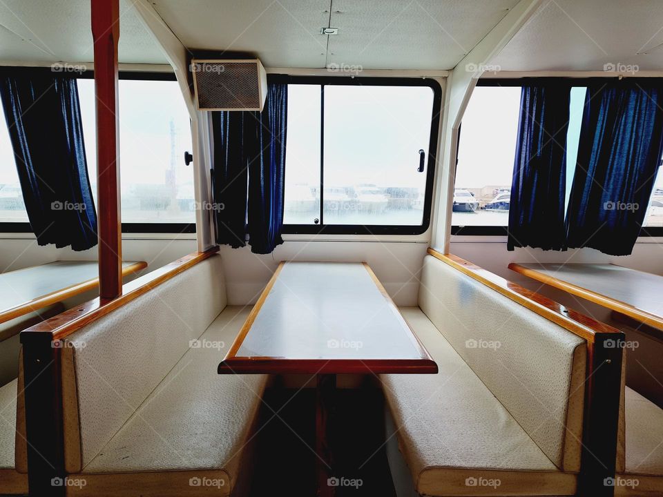 boat interior cabin with armchairs and tables