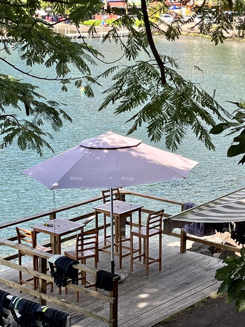 View of a wooden terrace with an umbrella overlooking the Caribbean Sea