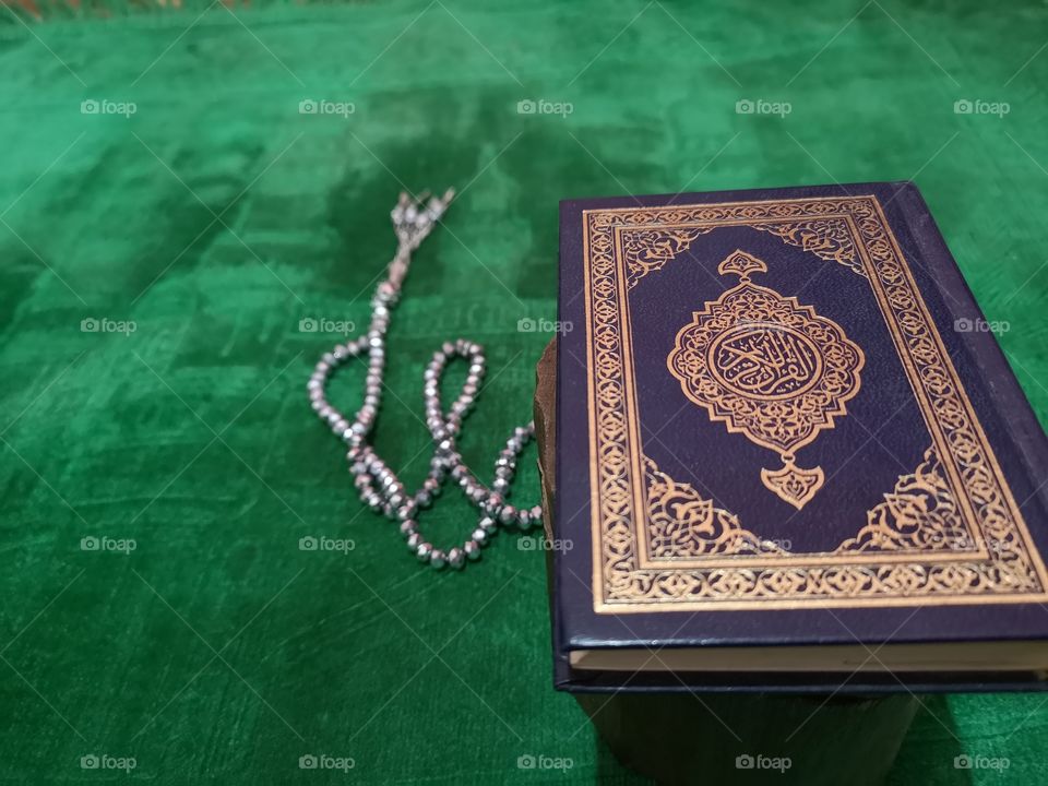 Al-quran on paraying mat with rosary bead. Islam and muslim concept