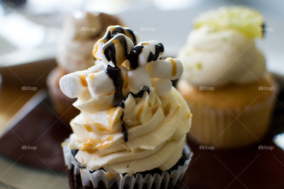 Crazy cupcakes chocolate caramel and marshmallow decadent dessert treat on plate of cakes 