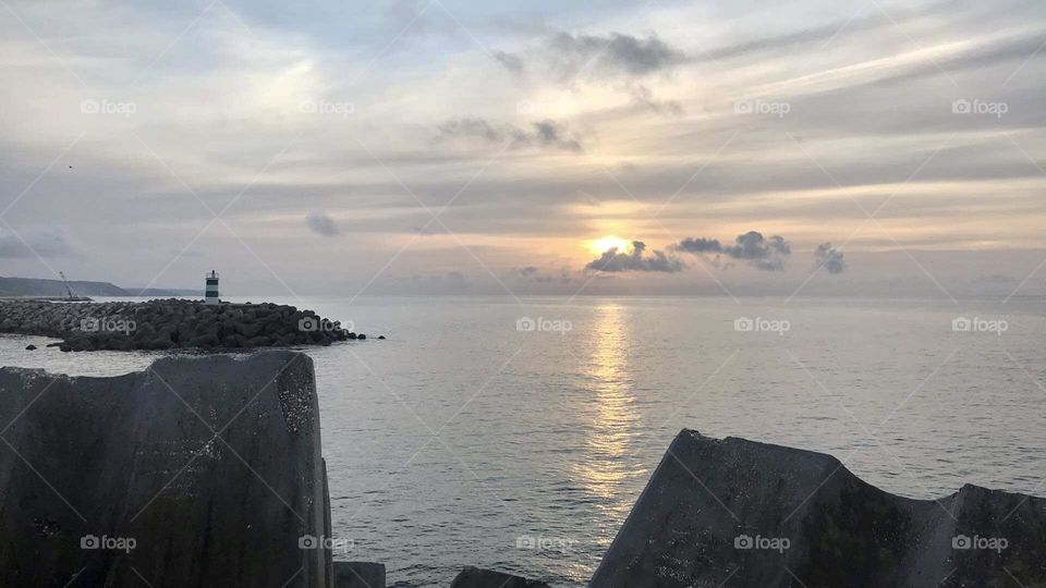 Seashore Sunset and lighthouse 