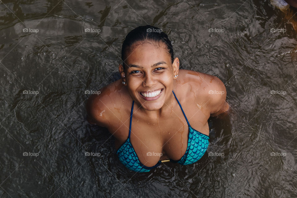 Brazilian girl swimming in the river