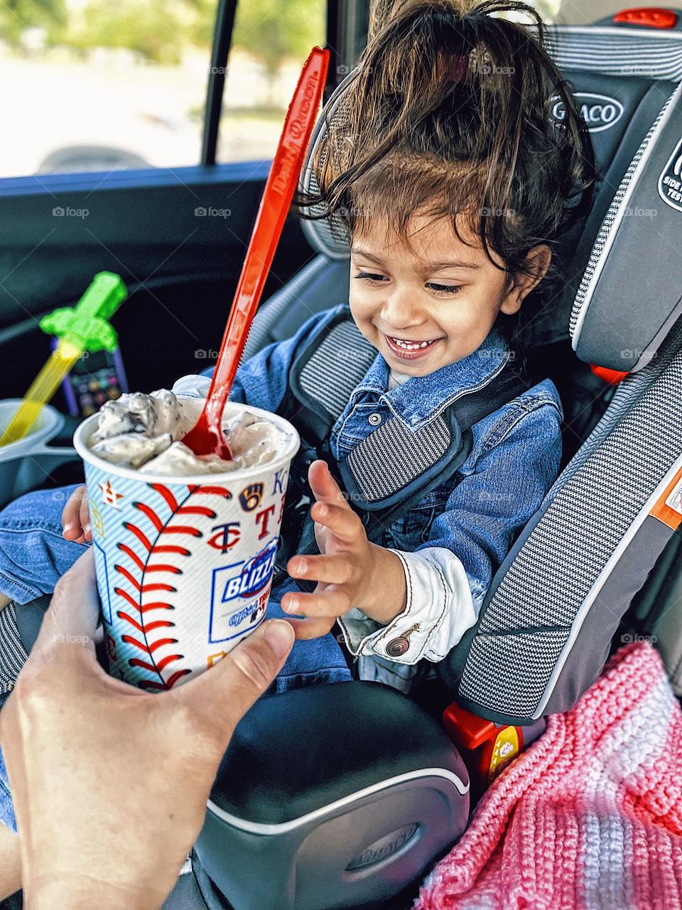 Mother handing little girl ice cream, little boy be is excited about ice cream, little girl happily looks at Blizzard from Dairy Queen, summertime treats