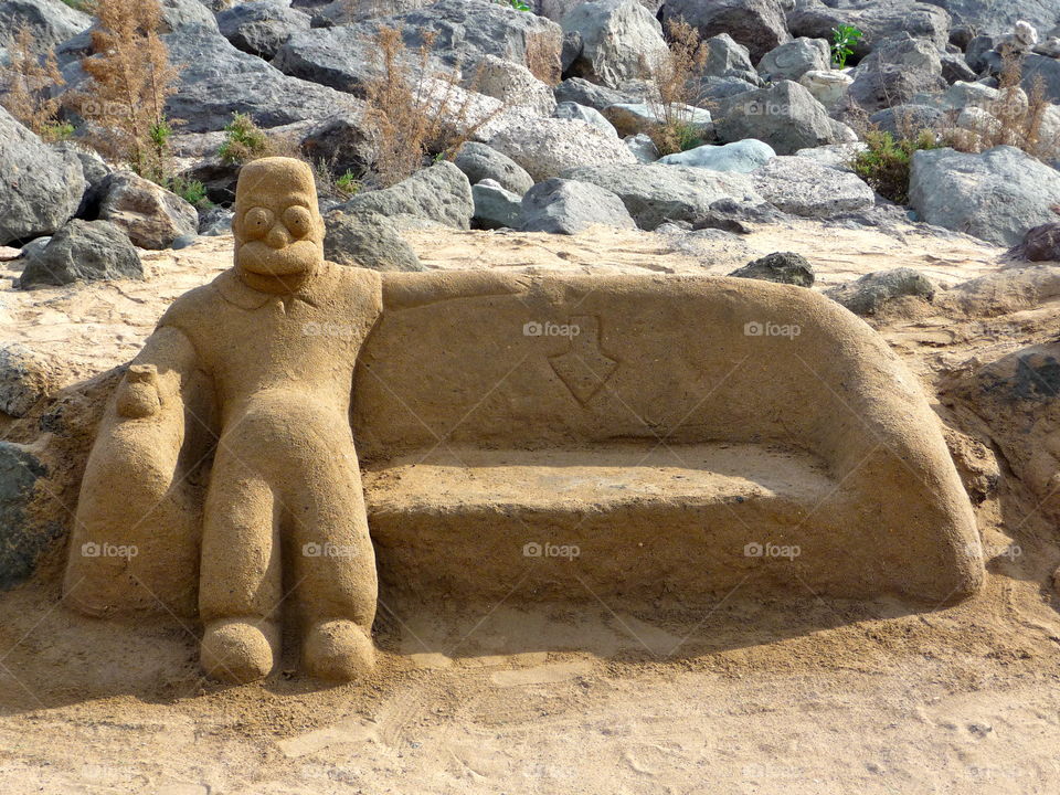 Take a seat. The place next to Homer is available. Beautiful Sand Art - seen on the beach of a Canary Island