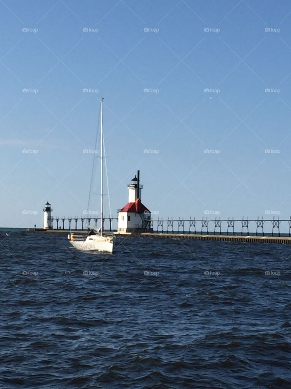 Lighthouses and sailboat on Lake Michigan at Saint Joseph 