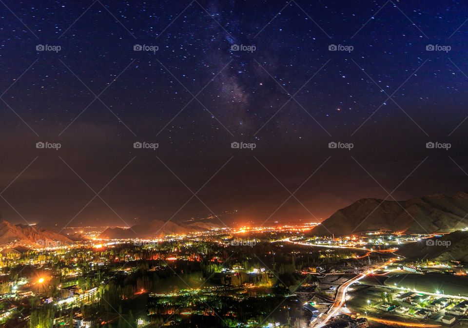 magical starry sky above city lights