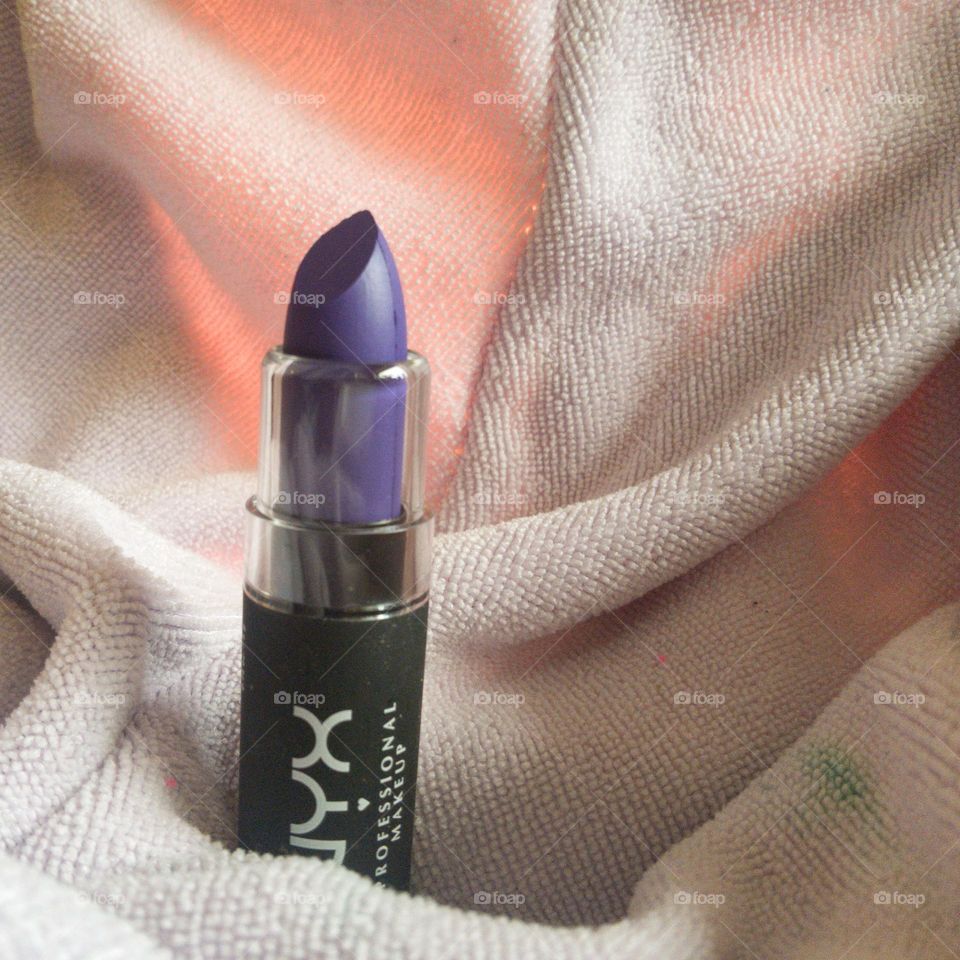 A bright purple lipstick from NYX.