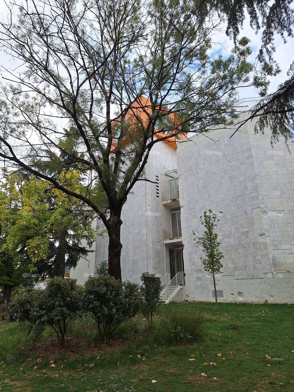 orange cube at the top of the marble building