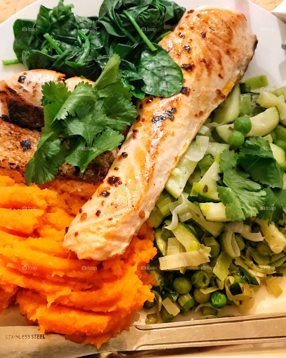 Vibrant sweet potato mash and salmon with steamed vegetables 