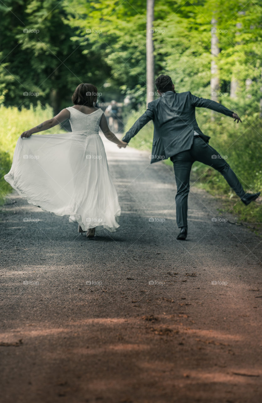 a happy couple of novices jumping in the woods