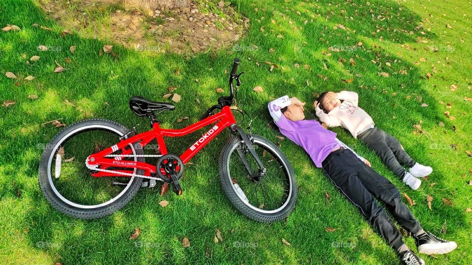 Kids Lying with the Bike