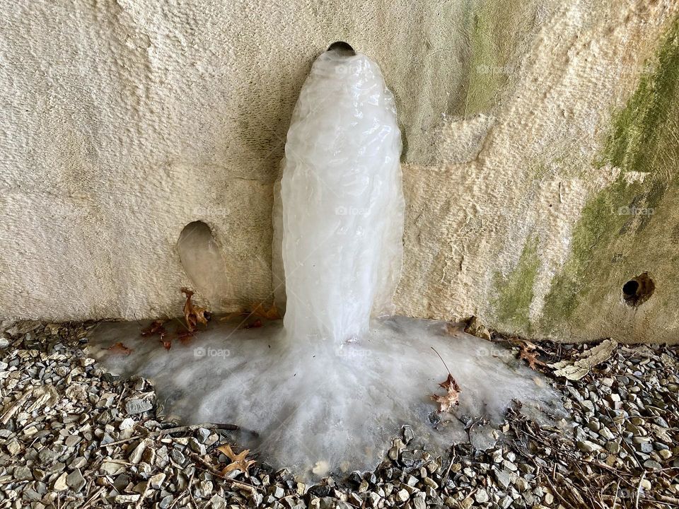 Ice on the side of a tunnel formed from water coming out of a pipe