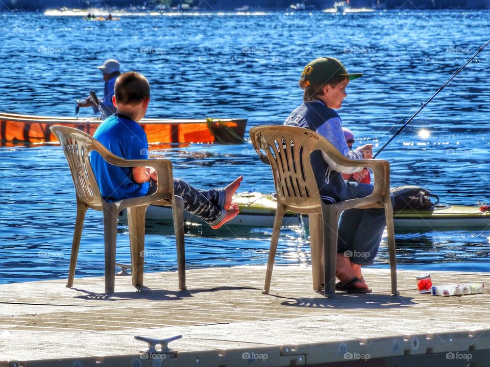 Little Boys Fishing At The Lakeshore. Boys Fishing On A Lake
