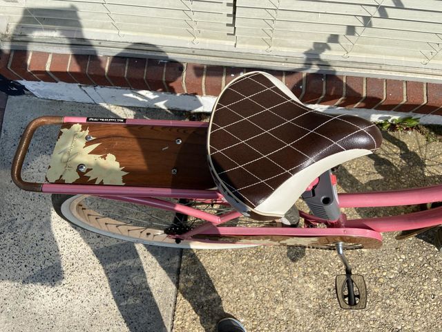 My shadow is visible snapping a photo of this pretty pink bike that was parked outside a beauty salon. 