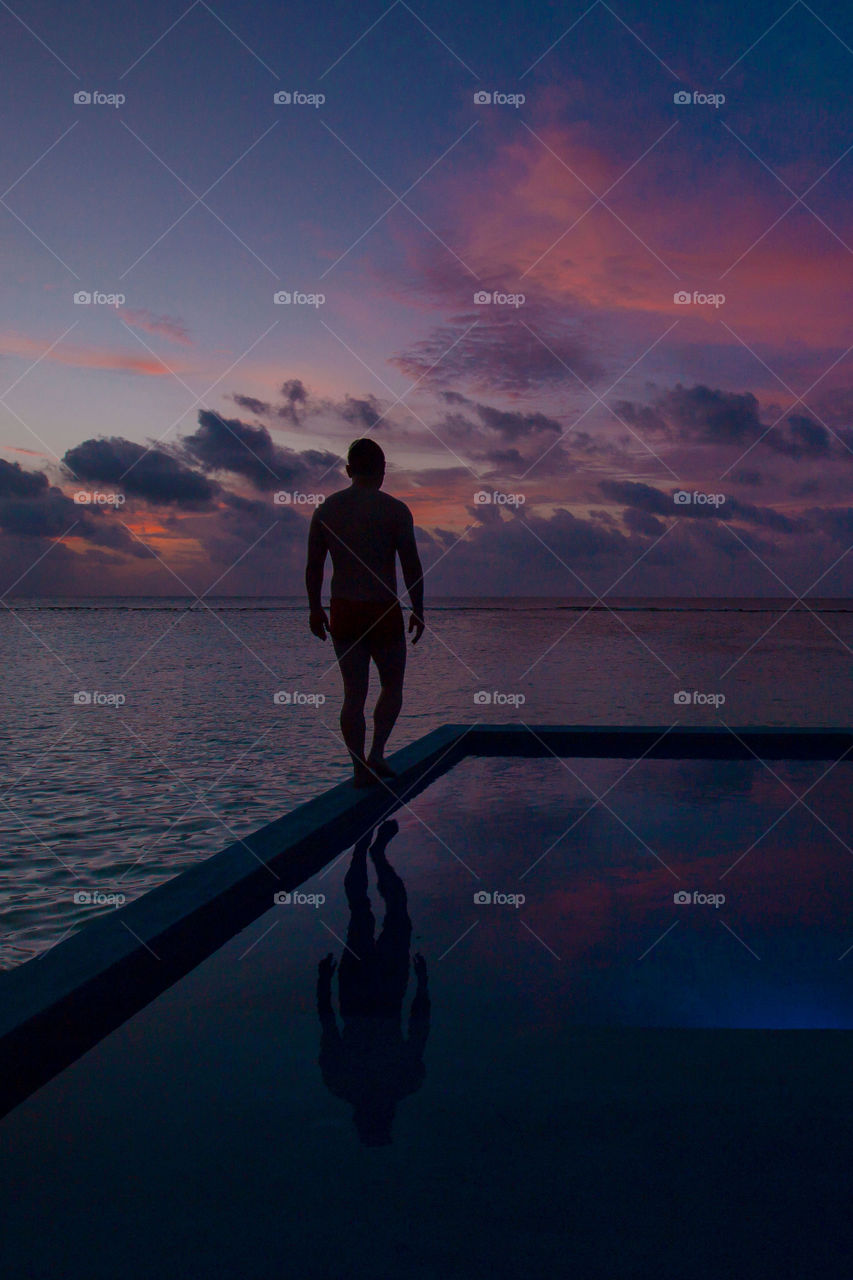 Man about to get in the pool 