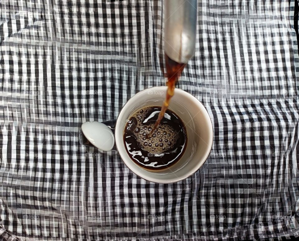 Cup of coffee over optical background