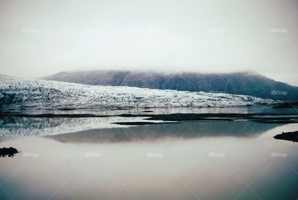 Reflection of mountain range on lake during winter