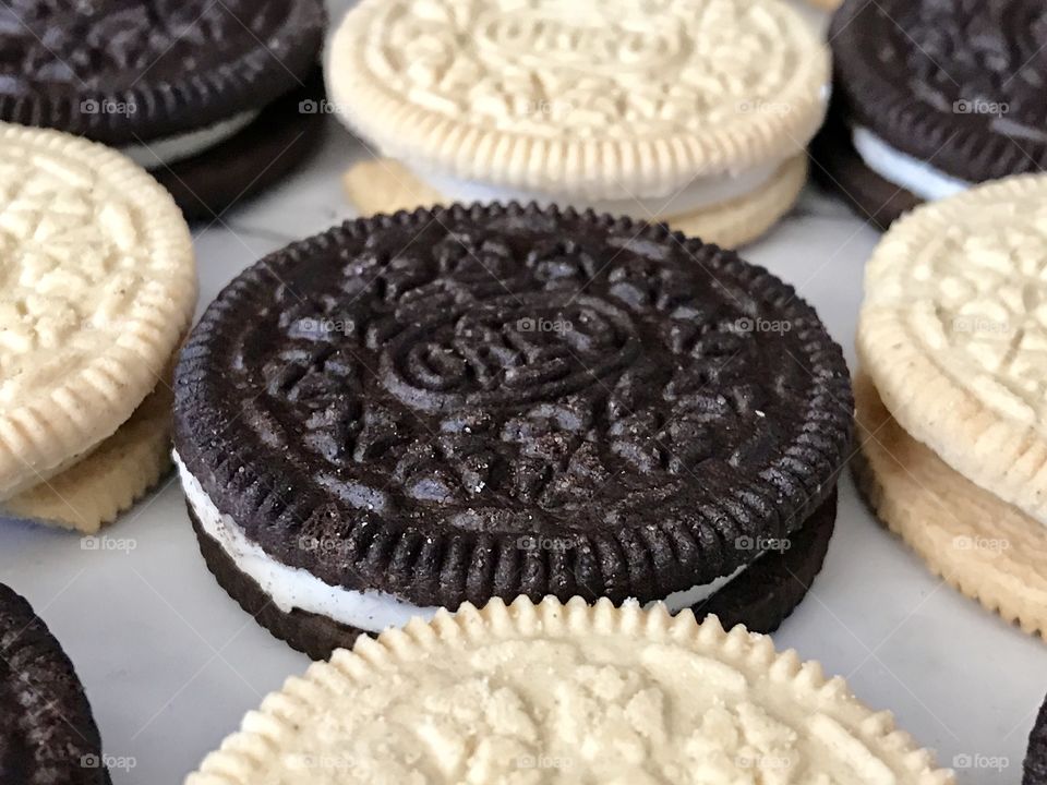 Golden and chocolate double stuff Oreo cookies in a contrasting flat lay