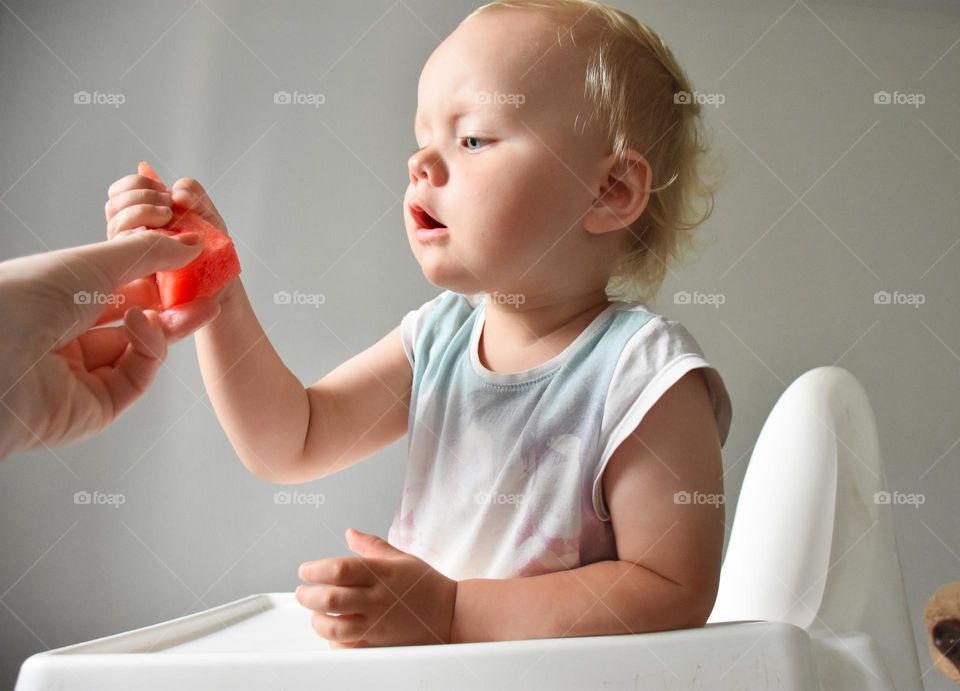 Toddler eating watermelon 