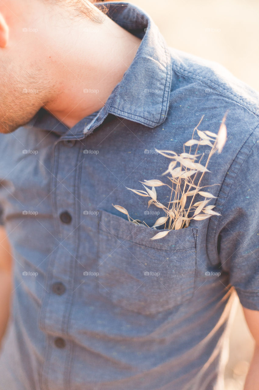Dry plants in the pocket of man shirt