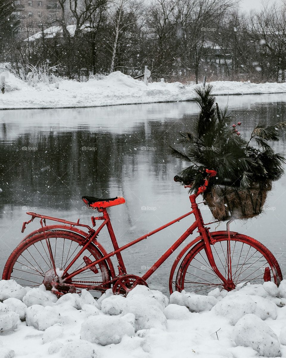 lovely red bicycle and snow falling