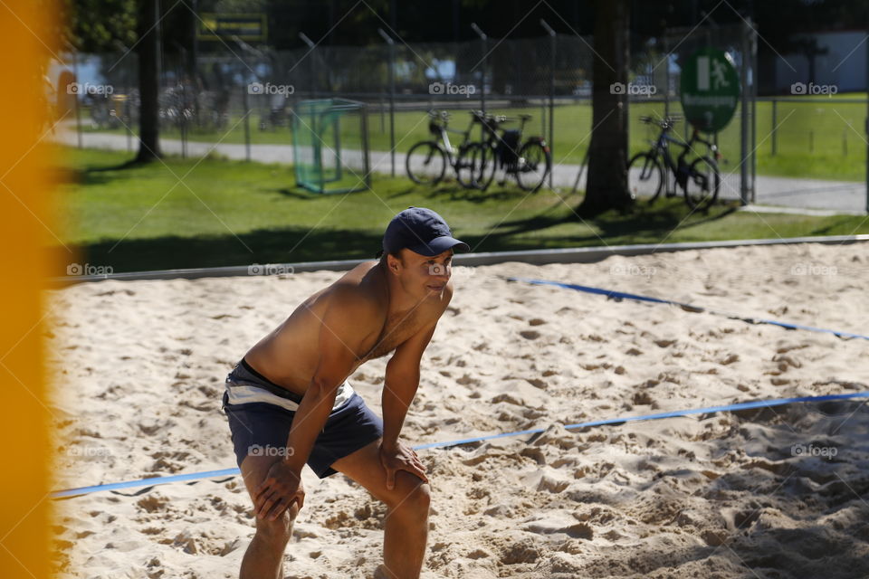 Beachvolleyball player ready to receive the serve.