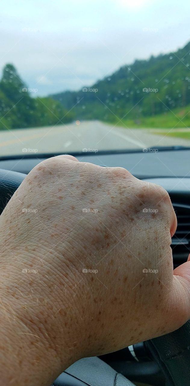 hand on steering wheel