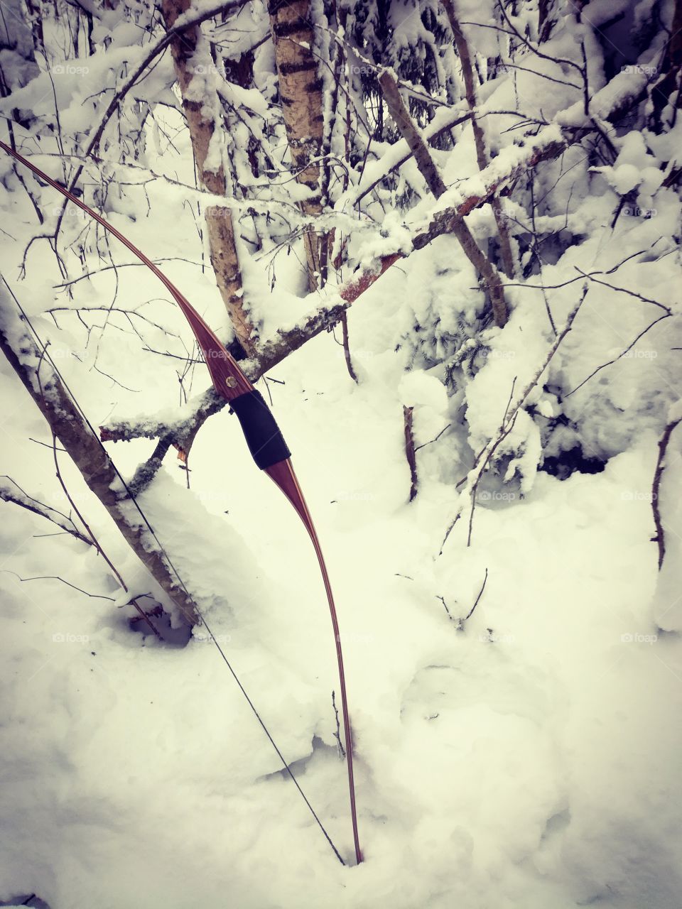 archery with traditional bow in snowy forrest in Sweden