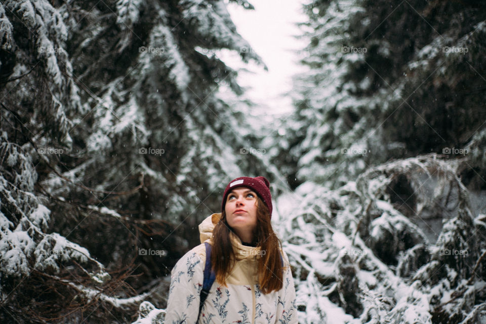 woman looking up towards the snowy sky