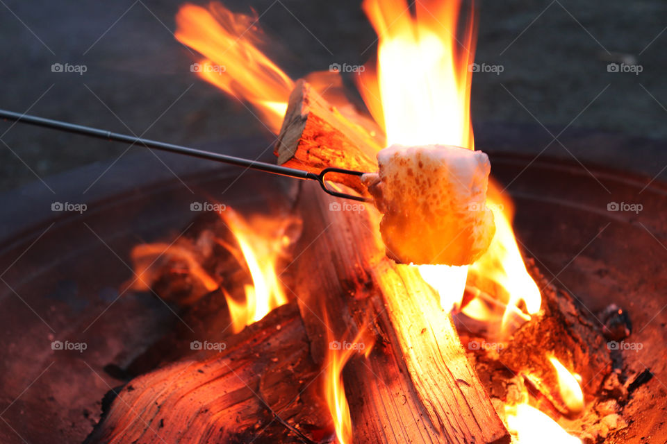 Making smores over a wood burning fire