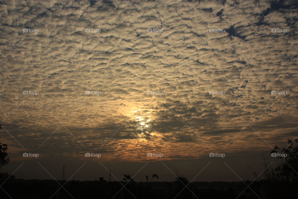 a sunrise with clouds all around