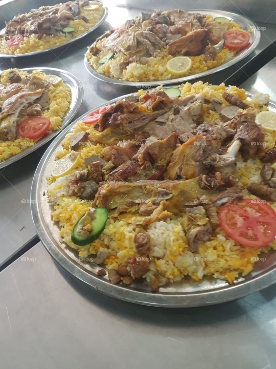 Laham Mandi or Lamb Mandi is a Saudi Arabian Traditional dish which is also very popular in other middle eastern countries like United Arab Emirates, Qatar, Kuwait, Oman and yemen.This photo was snapped while preparing to serve the wedding guest.