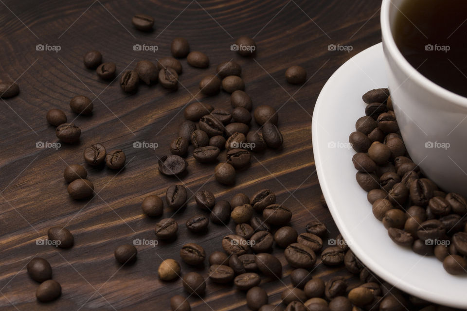 top view of coffe cup and beans on wooden table