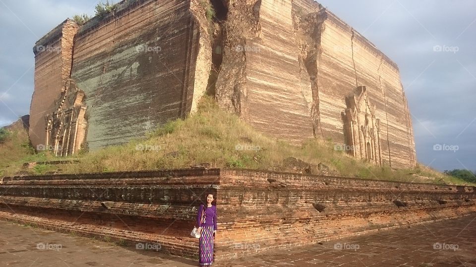Woman standing in front of Pagoda temple, Myanmar