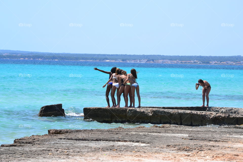 girls making photos on the beach