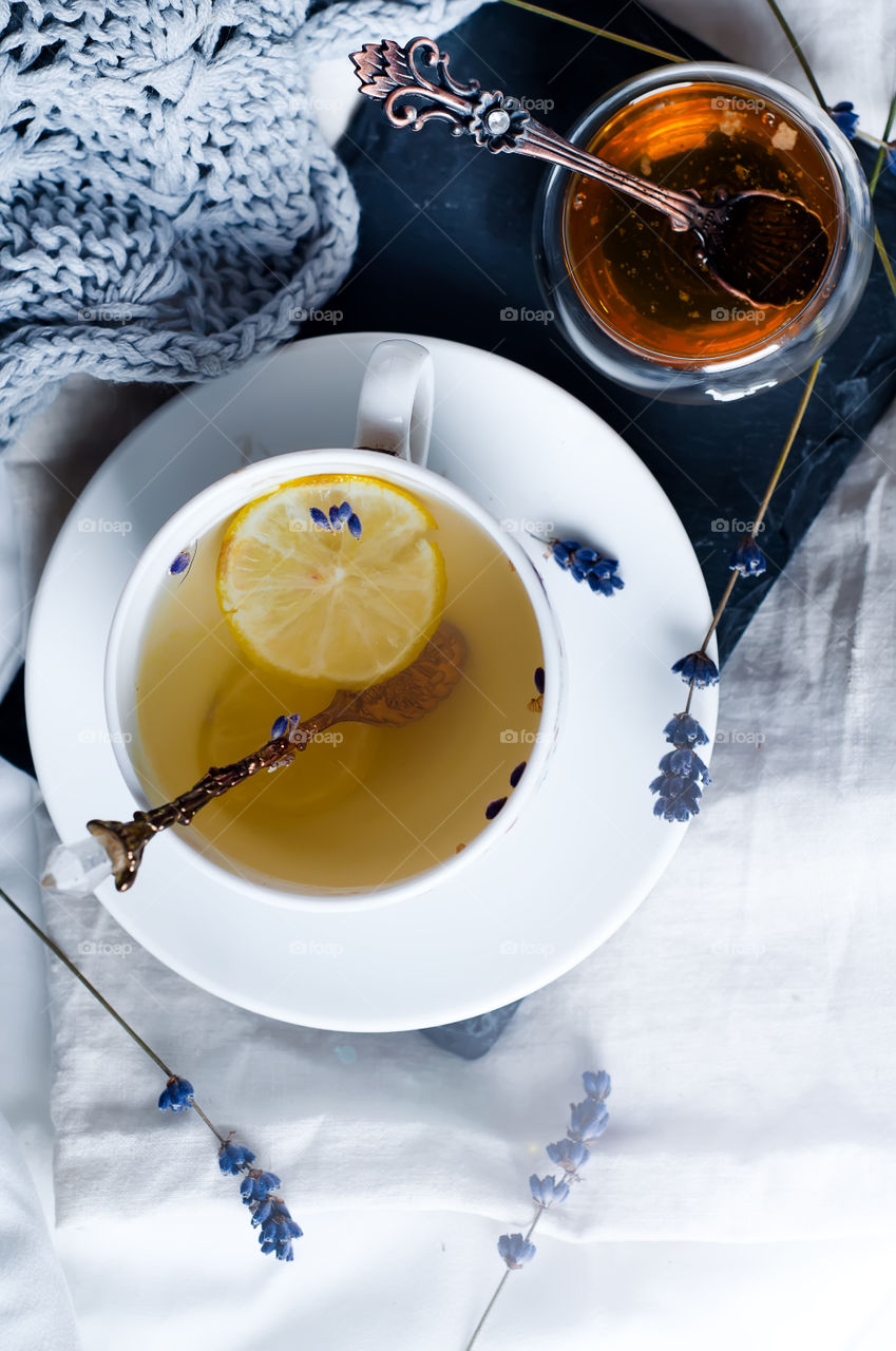 Warm cup of tea with lemon and honey on a bad