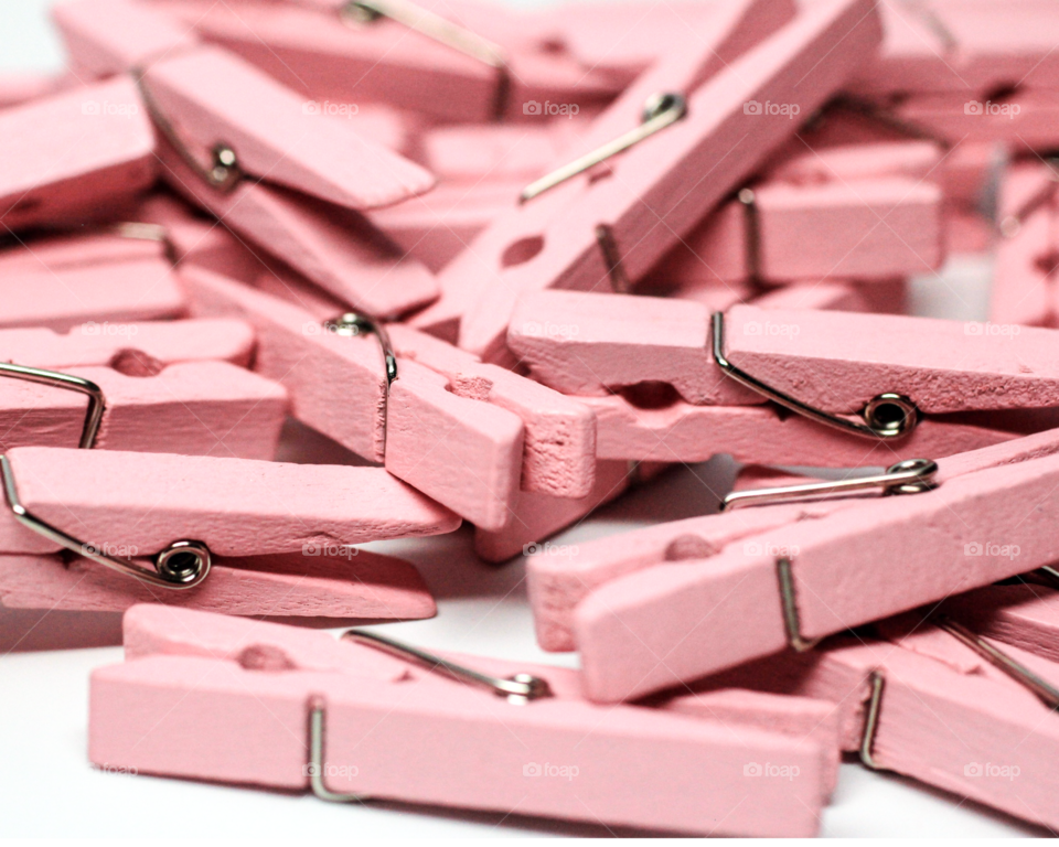 Pile of pink clothes peg