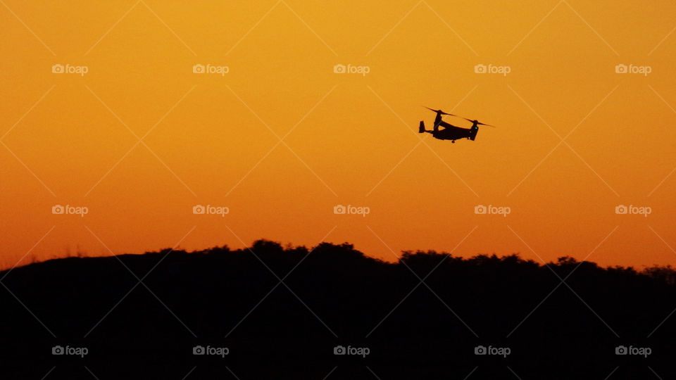 V-22 Osprey flying over Wiltshire, UK, at dusk.