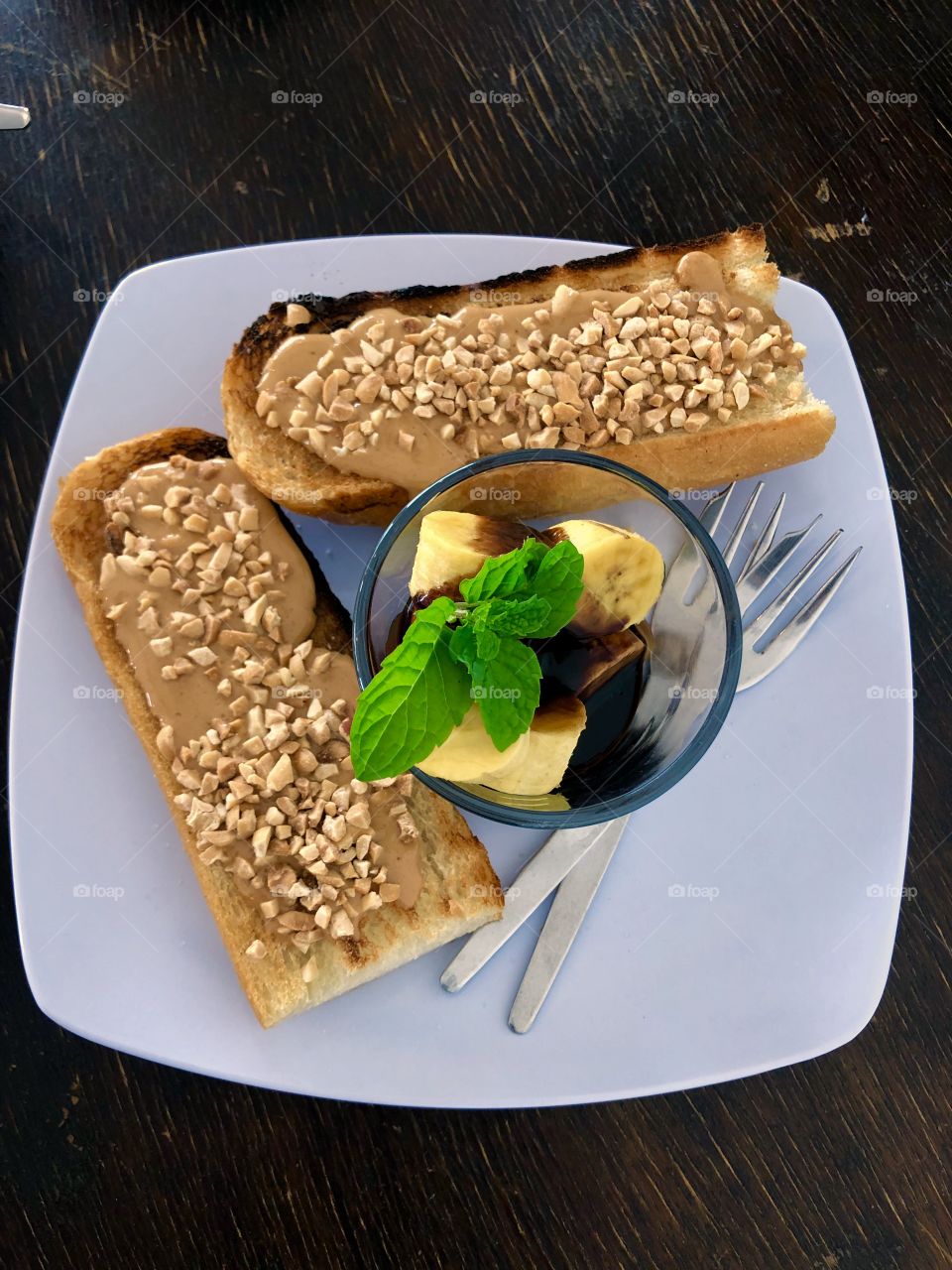 Fresh banana cuts, chocolate sauce and peanut butter toast bread 