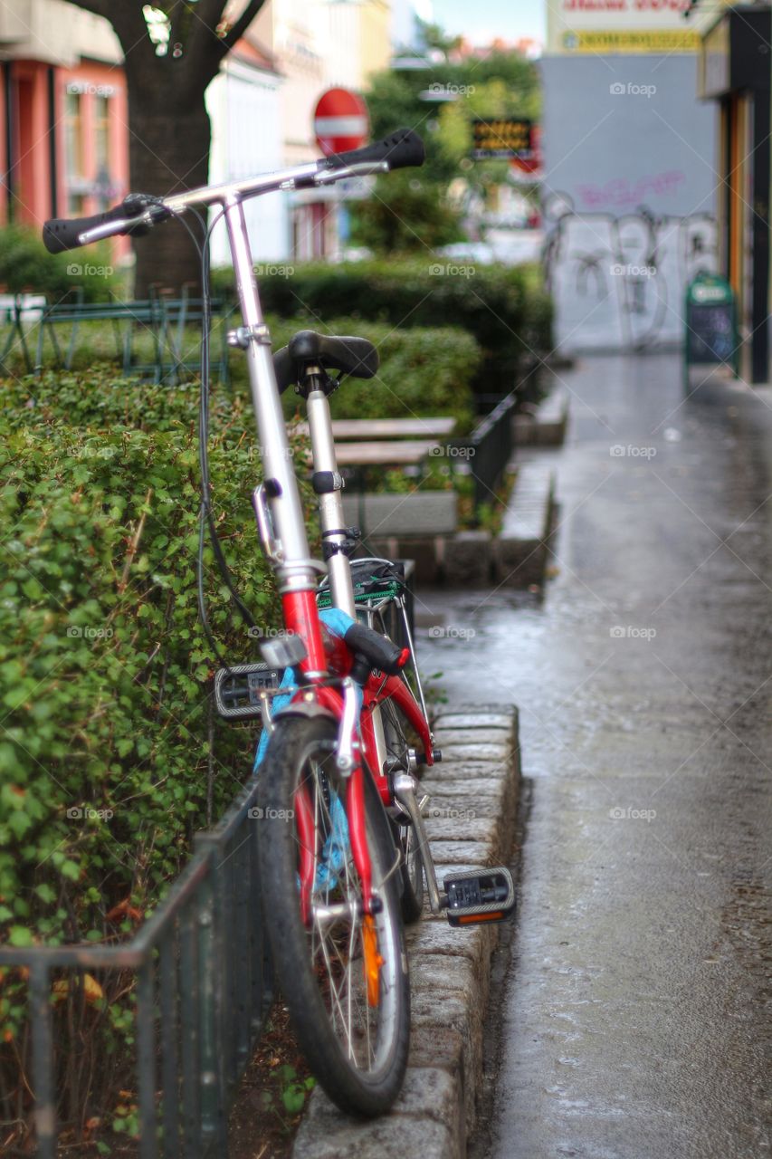 A lonely bike left in the rain 
