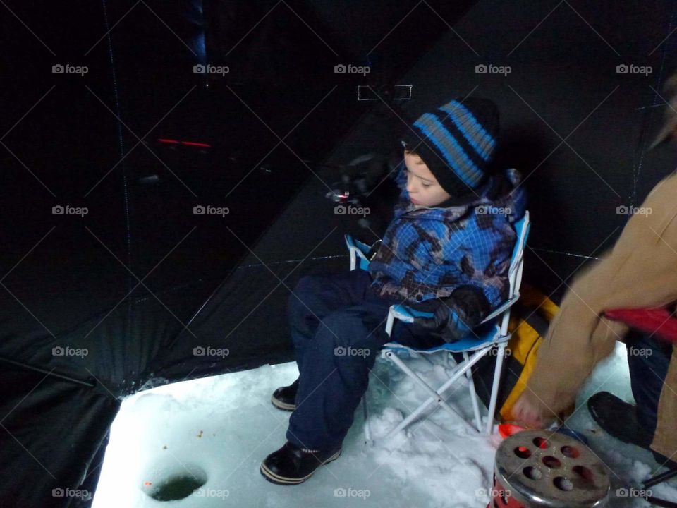 Ice fishing in a tent.