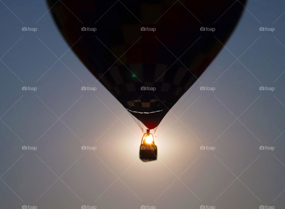 Hot Air Balloon Passing Morning Sun. I got lucky when I snapped this photo as a hot air balloon passed in front of the early morning sun.
