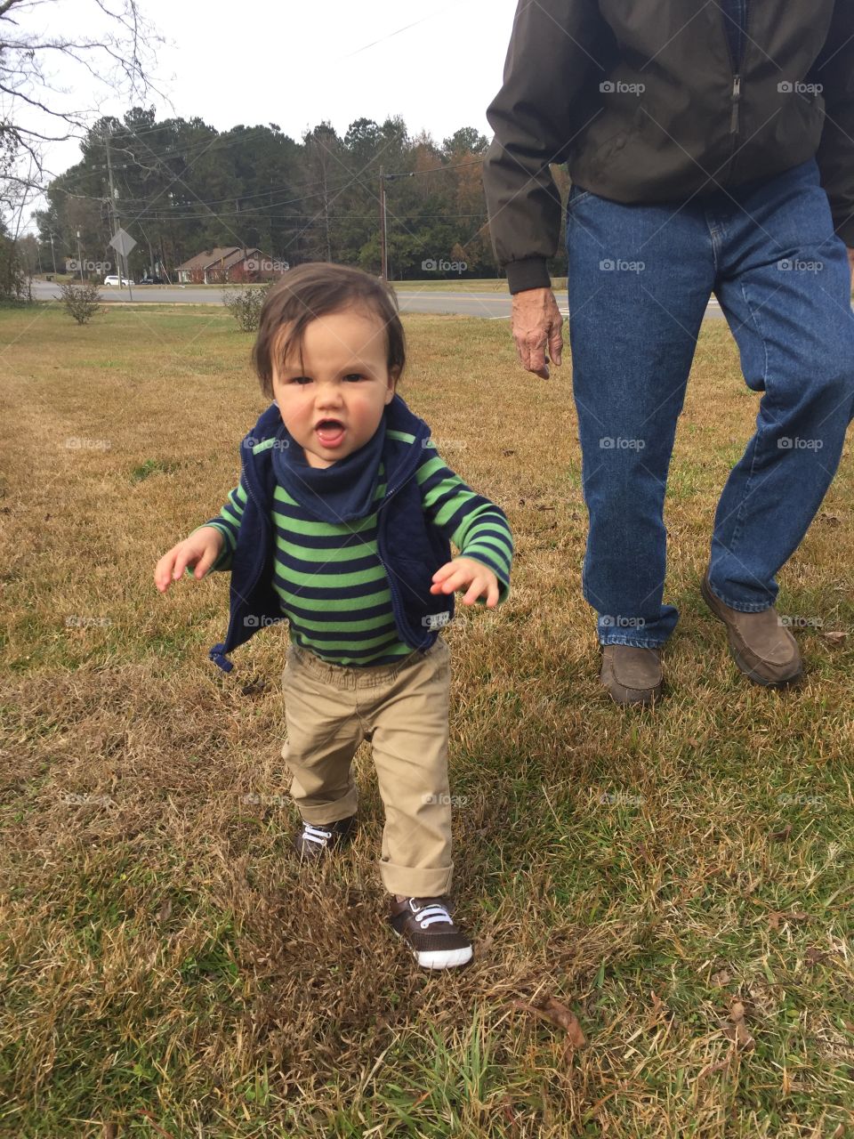 Papa chasing our little grandson in the yard who thinks he’s getting away ! 