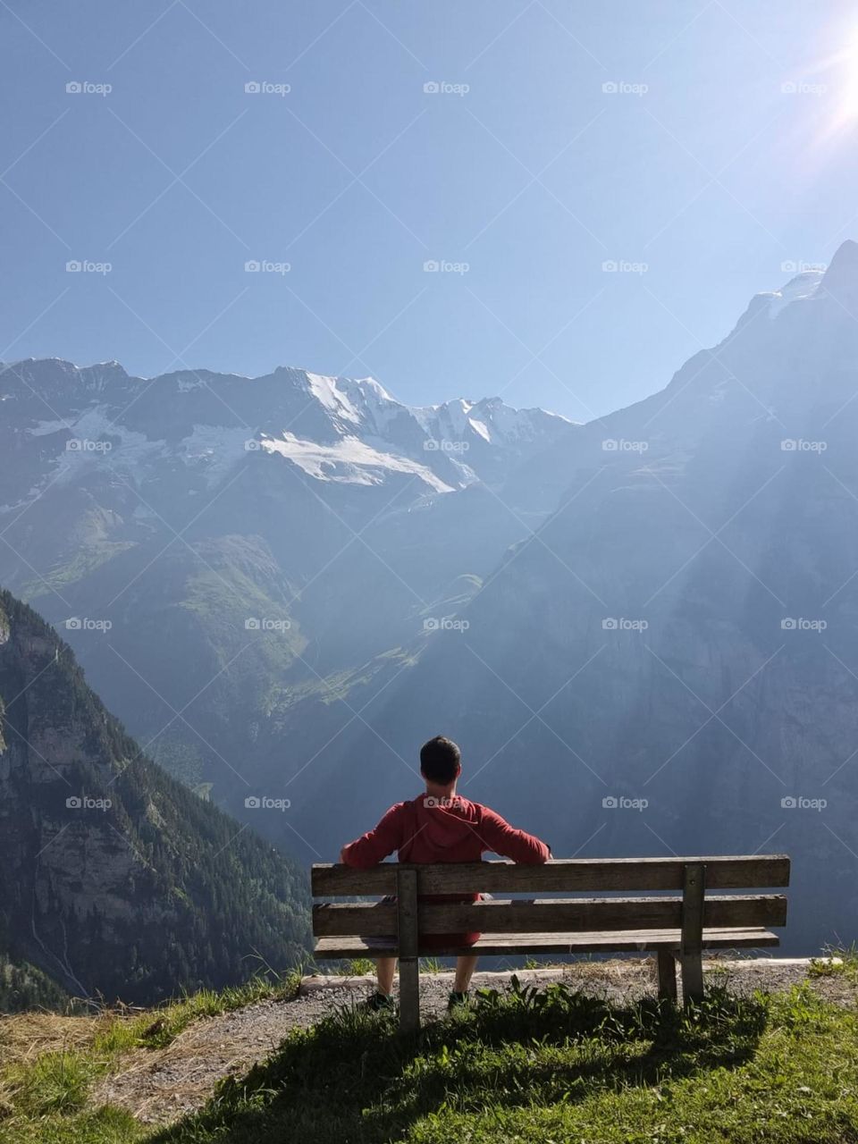 Young man enjoying the sunrise  and mountains in swirzerland