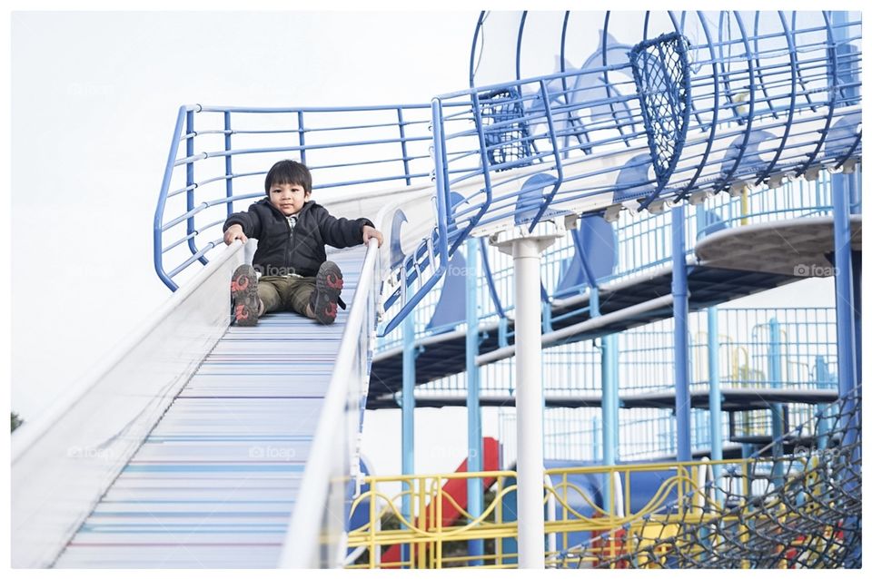 Japanese boy sliding down