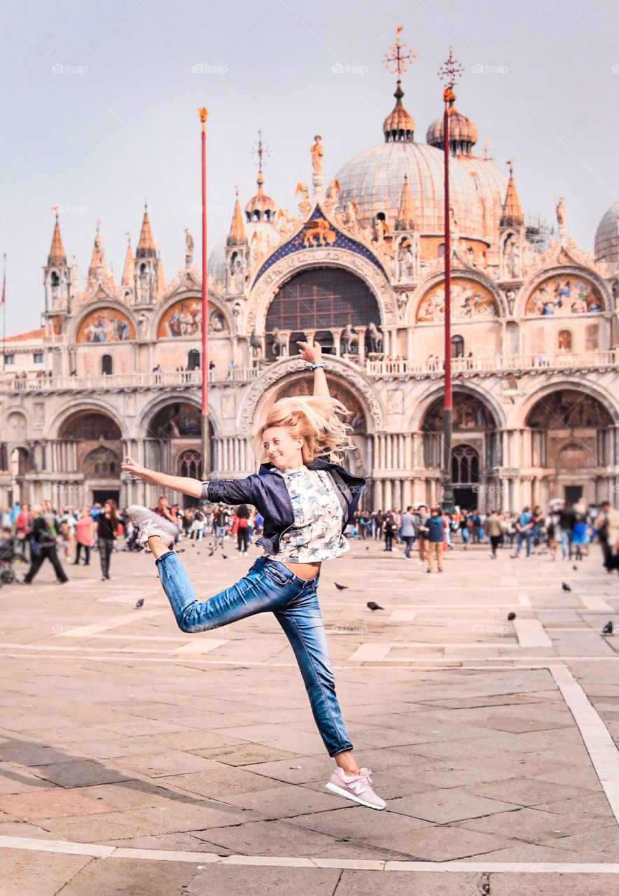 Happy jumping girl on square 